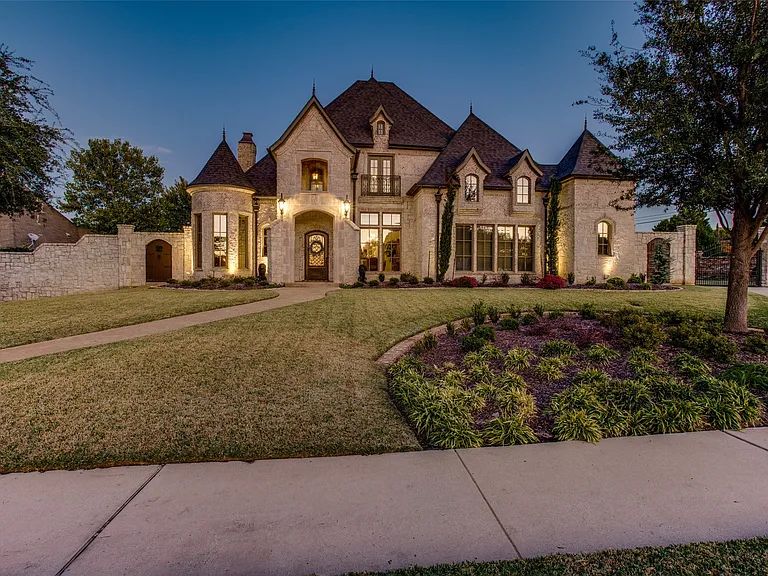 Stone estate softly lit at dusk